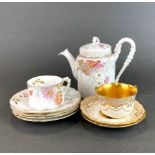A 19th century German porcelain teapot, cup and saucer and three spare saucer together with a