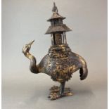 An Oriental gilt bronze censer in the form of a crane with a pagoda on its back, H. 46cm.