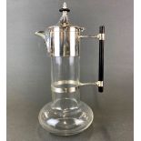 A Christopher Dresser style silver plated claret jug, H. 28cm.