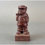 A carved fruitwood figure of a bearded gentleman smoking a pipe, H. 10cm.