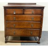 A 1930's five drawer oak chest with acorn handles, W. 97cm, H. 110cm.