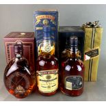 Four bottles of whiskey: Glenmore, Dimple, Johnny Walker Black Label and Chivas Regal.