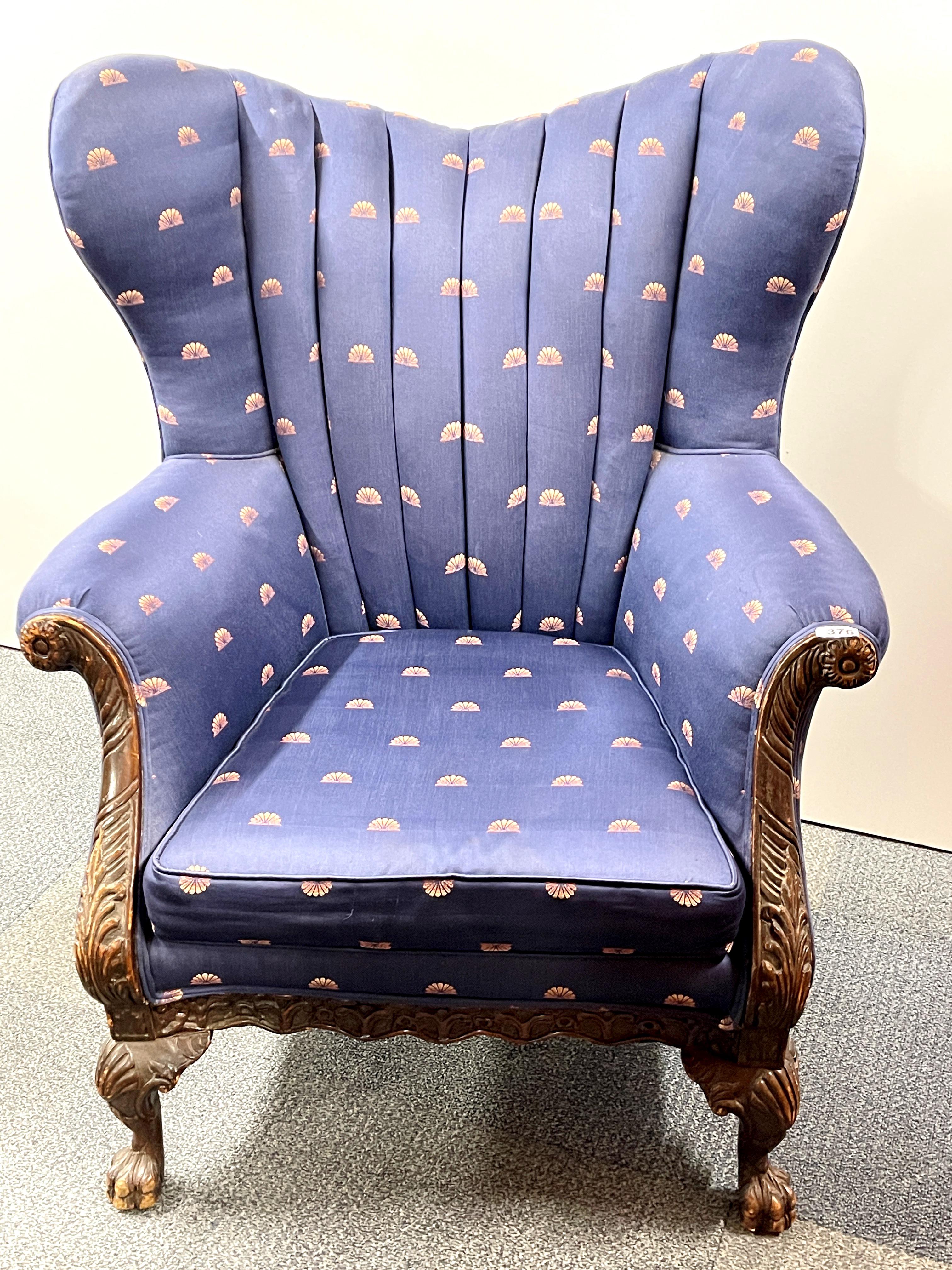 An antique upholstered carved wooden armchair, W. 88cm. H. 107cm.