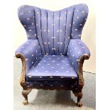 An antique upholstered carved wooden armchair, W. 88cm. H. 107cm.