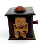 An amusing Japanese mid 20th Century wood and bakelite toy, 8 x 8 x 8cm.
