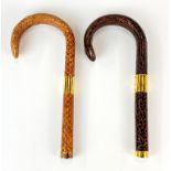 Two gilt mounted snake skin covered walking stick/umbrella handles, L. 19cm.