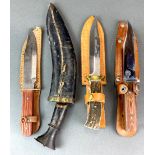 A group of four knives, three hunting and one Gurkha.
