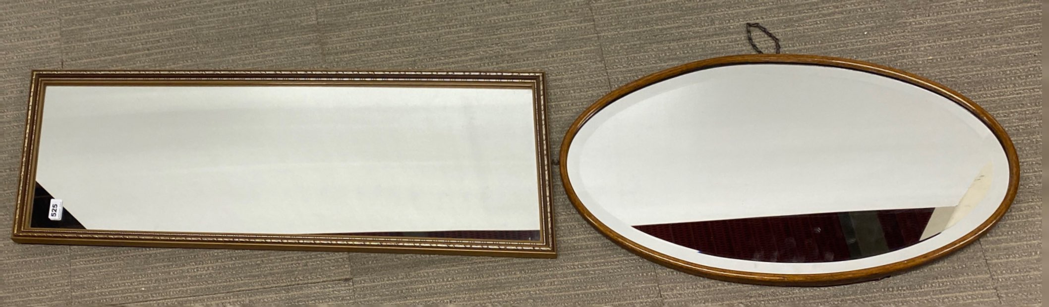 A gilt framed mirror, 34 x 97cm, with an oval oak framed mirror.