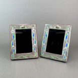 A pair of Art Nouveau style enamelled sterling silver and wood photograph frames, H. 17cm.