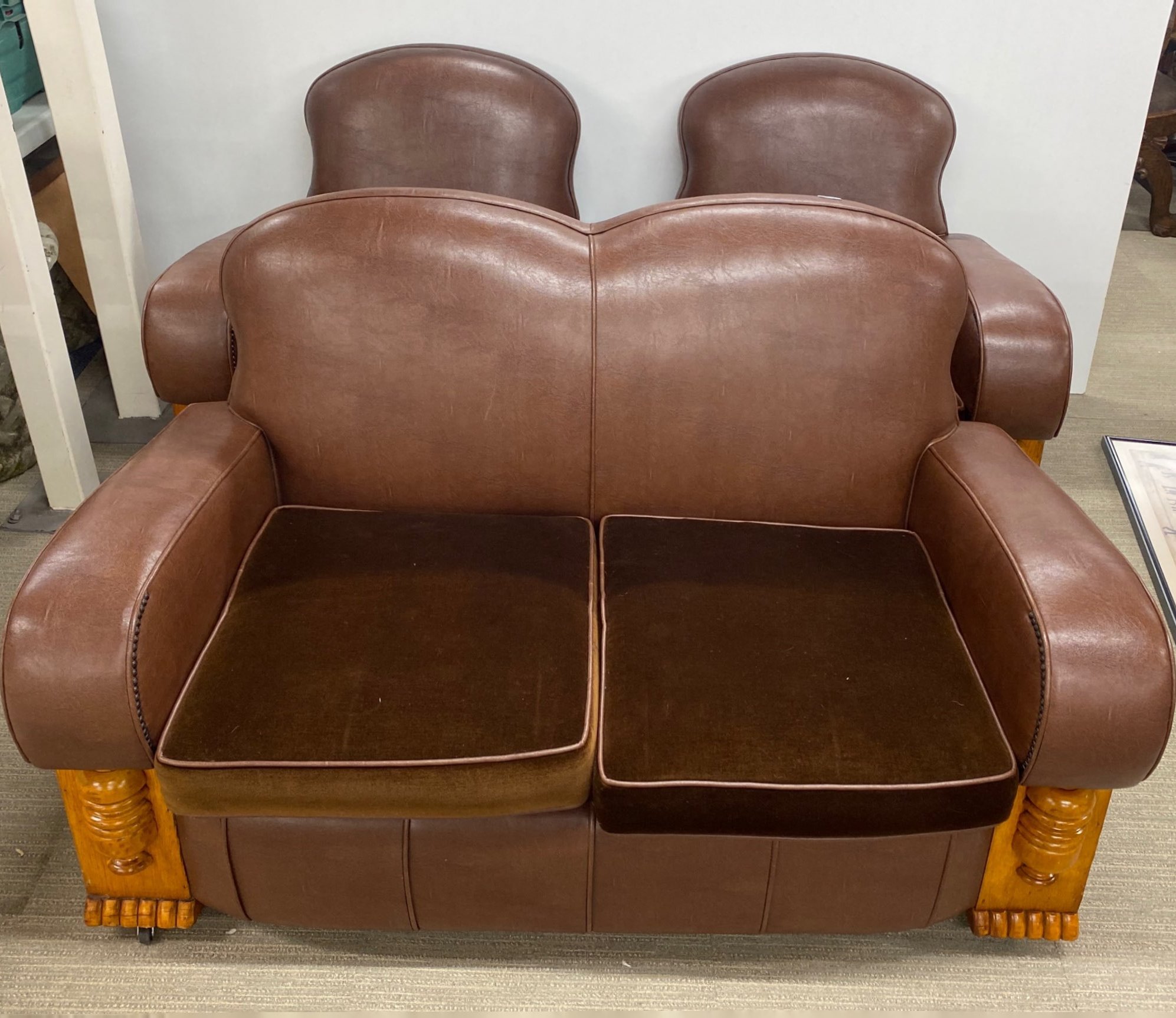 A superb Art Deco re-upholstered three piece suite, settee W. 140cm.