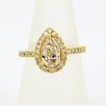 An 18ct yellow gold (stamped 18K) ring set with a pear cut diamond, approx. 1ct, surrounded by