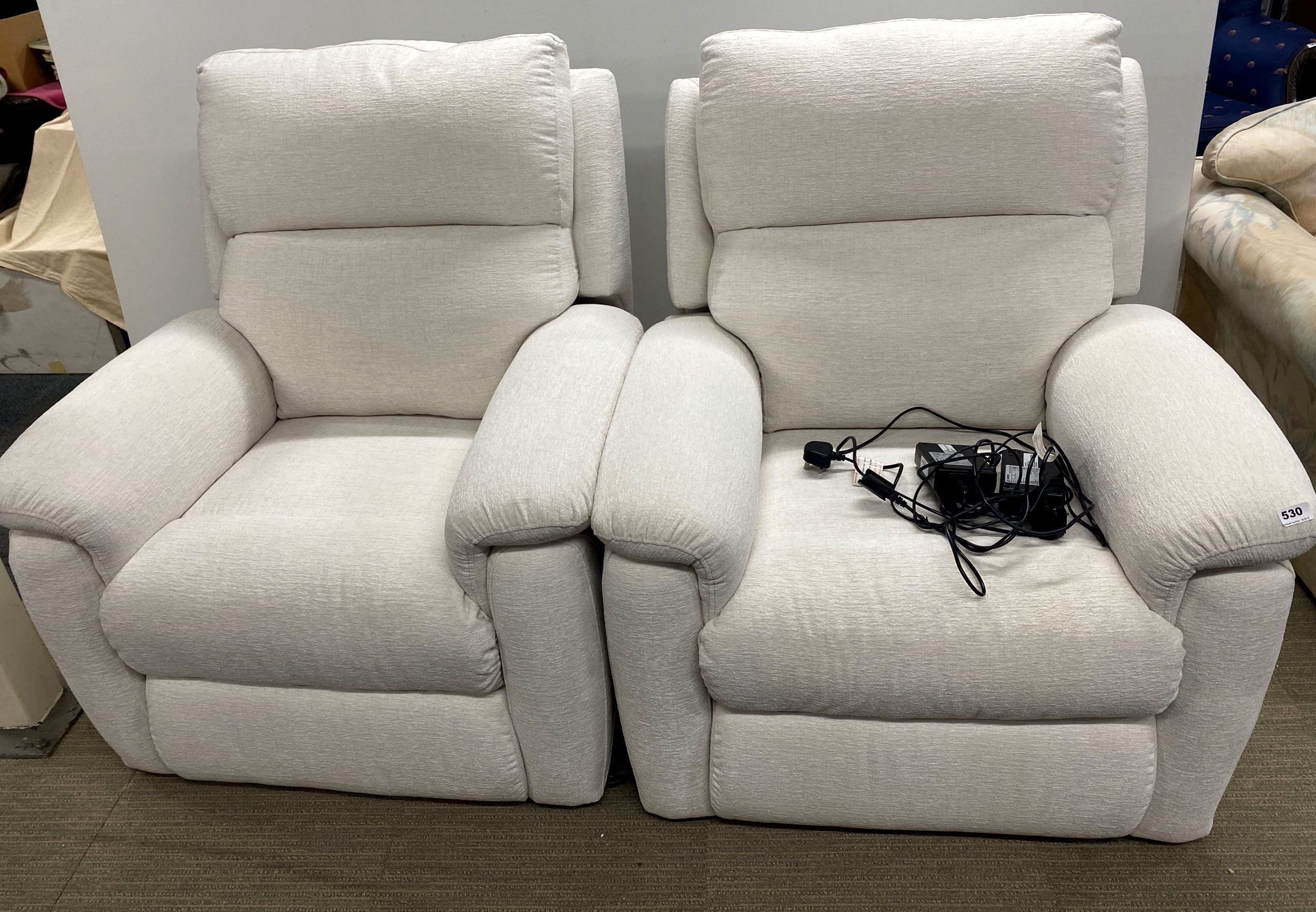 A pair of almost new electric recliner armchairs.