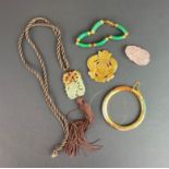 A group of Chinese jade jewellery and amulets