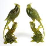 A fine pair of Chinese carved jade figures of phoenix with carved wooden bases, (one base missing