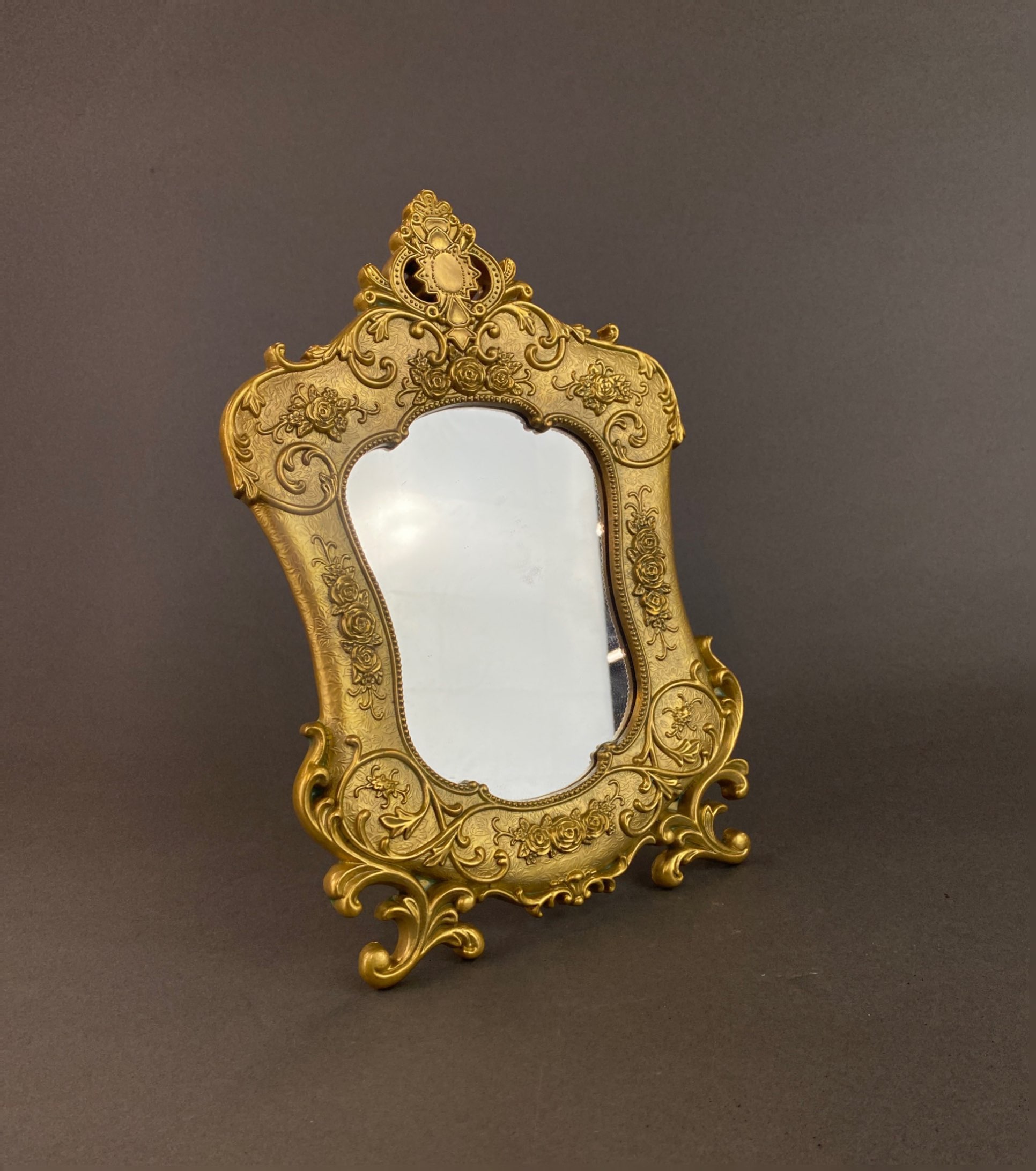 An ornate gilt metal free standing mirror, H. 30cm.