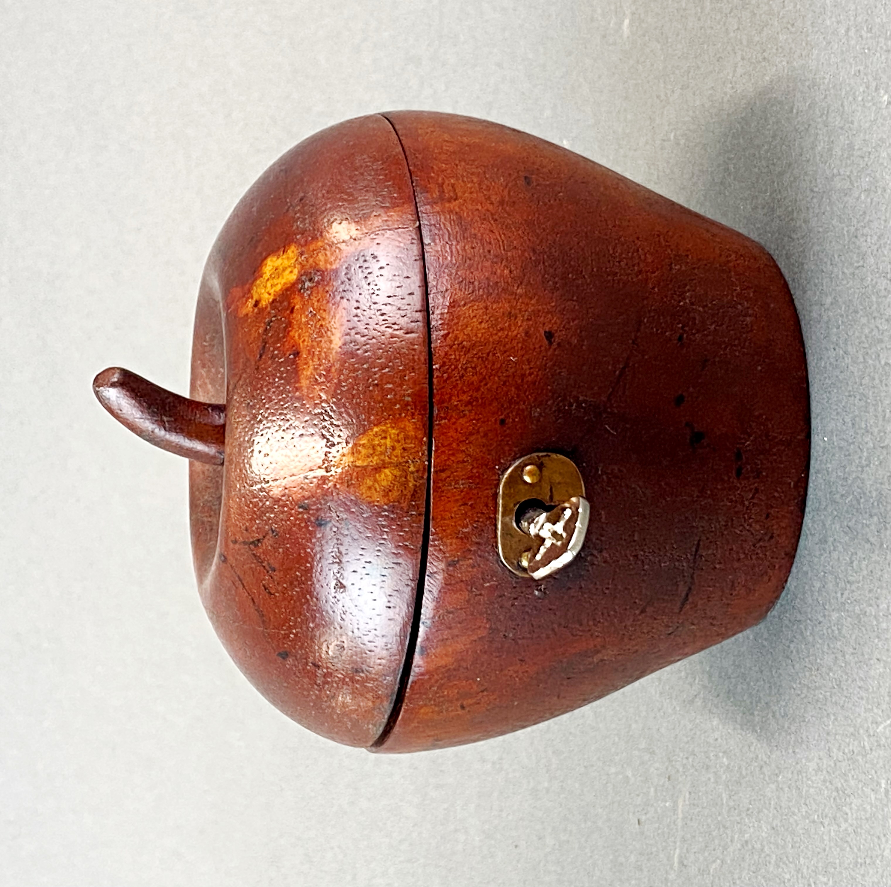 A wooden apple tea caddy, W. 11cm.