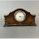 A 1920's oak cased mantle clock, W. 28cm. H. 15cm. understood to be in working order.