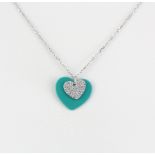 A silver heart shaped pendant set with cubic zirconia's on a 925 silver chain, L. 44cm.