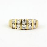 An 18ct yellow gold ring set with brilliant cut diamonds, (M.5).