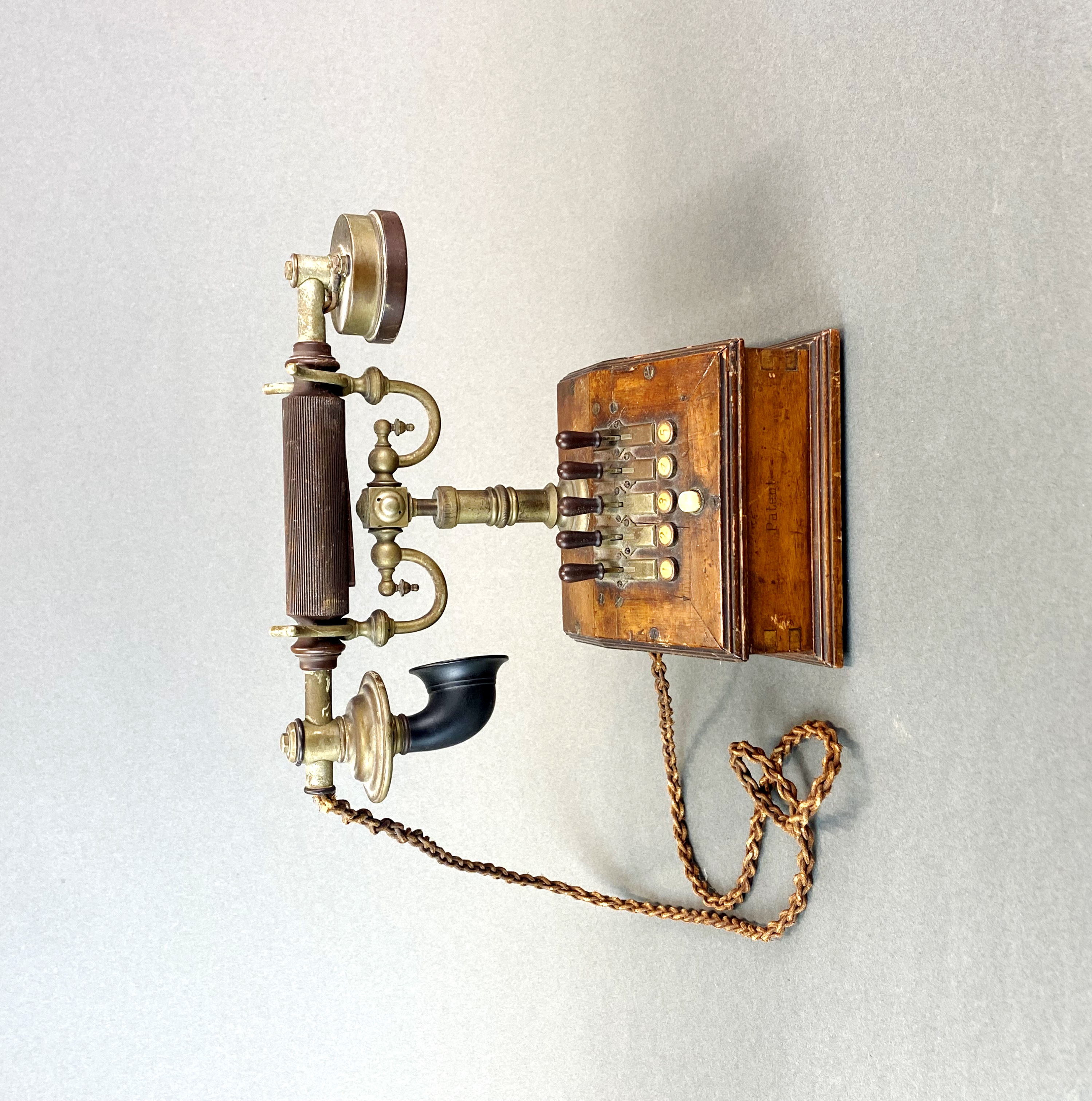 An early house telephone with five selection switches, H. 23cm.