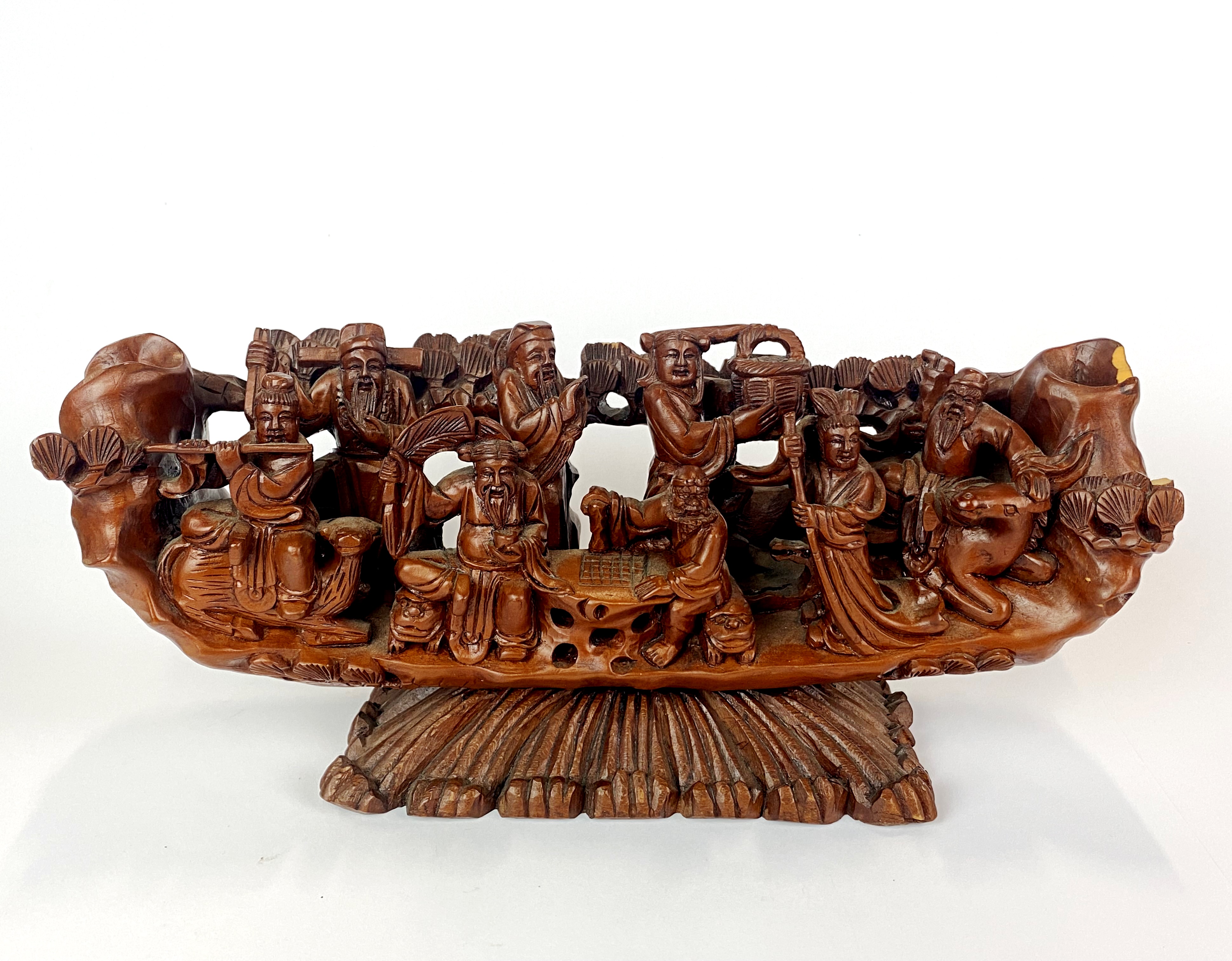 A Chinese carved wooden boat of immortals, L. 30cm, H. 14cm. Slightly A/F.