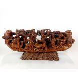 A Chinese carved wooden boat of immortals, L. 30cm, H. 14cm. Slightly A/F.