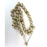Islamic interest. A large heavy string of silver (tested) prayer beads. Folded length 98cm, bead