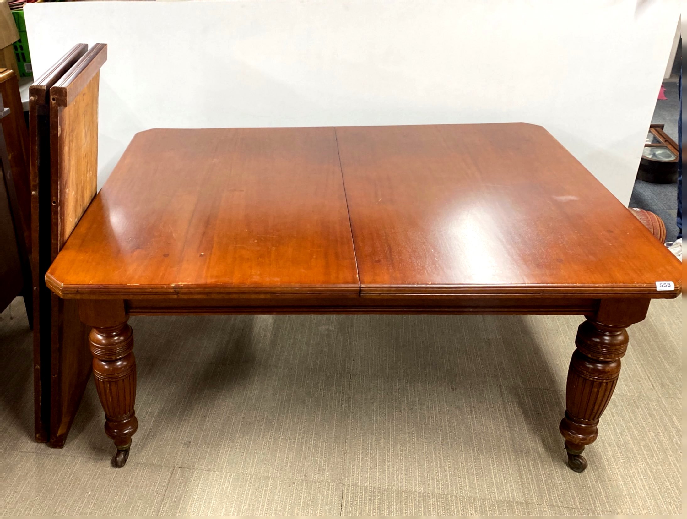 A Victorian mahogany wind out dining table, closed size 122 x 158cm, with two additional leaves,