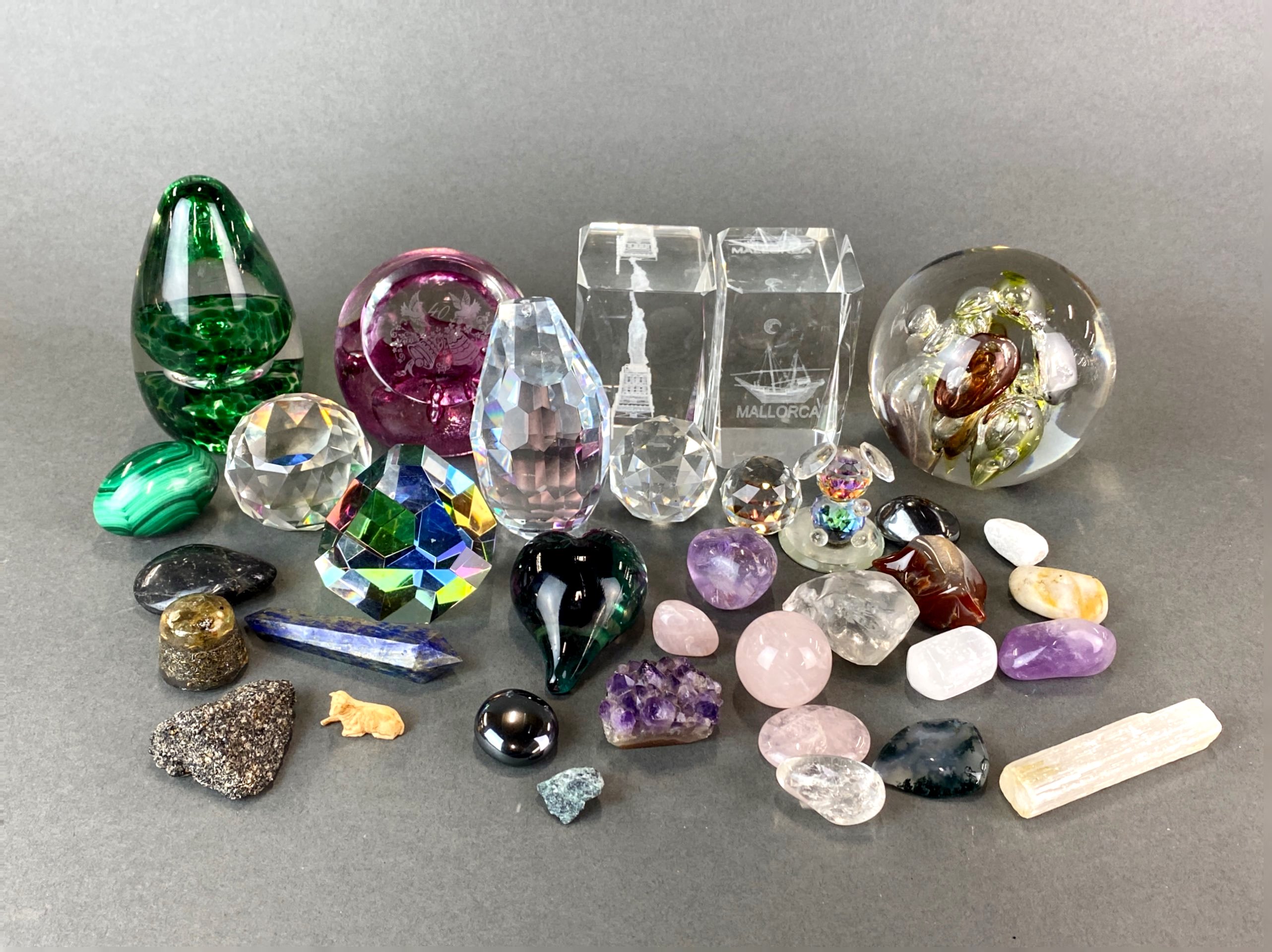 A group of glass paperweights including Caithness with a group of mixed minerals.