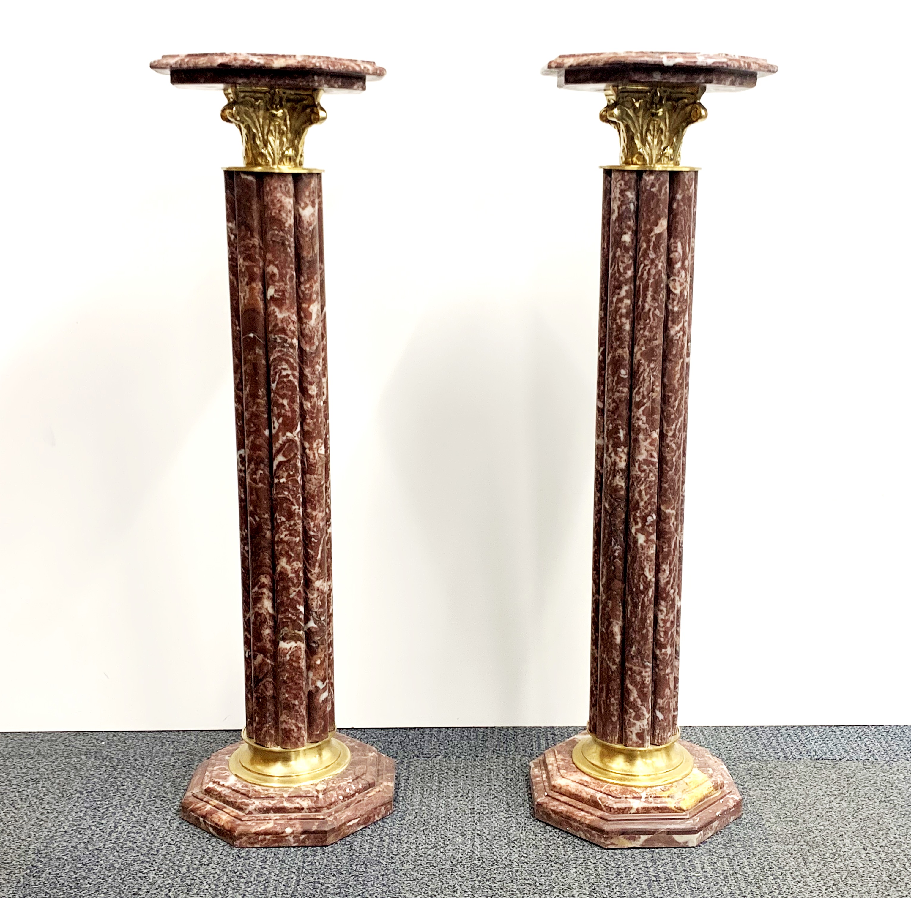 A superb pair of gilt brass mounted octagonal marble columns, H. 102cm. W. 29cm.