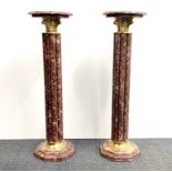 A superb pair of gilt brass mounted octagonal marble columns, H. 102cm. W. 29cm.