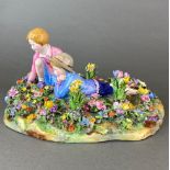 A Crown Staffordshire porcelain figure of two children among flowers, L. 30, H. 15cm. A/F.