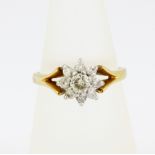 A 9ct yellow and white gold diamond set cluster ring, estimated approx. 0.50ct total, (P.5).