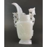A Chinese carved white jade/hardstone jug shaped item with integral ring decoration and mounted with