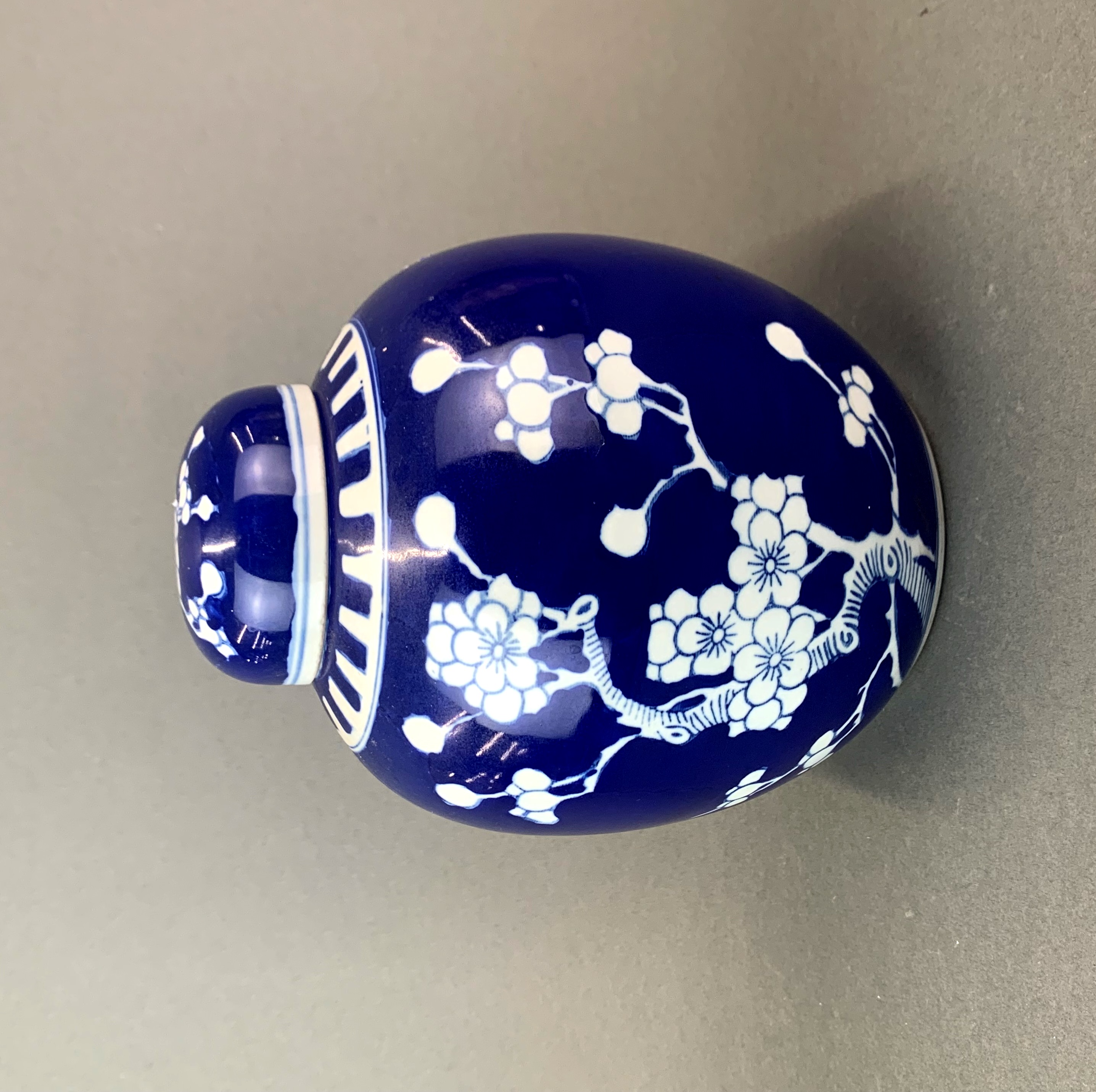 A Chinese prunus pattern porcelain ginger jar and lid, H. 21cm.