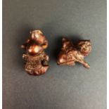 Two carved fruitwood figures/netsuke of a frog and a tiger, H. 6cm.