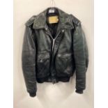 A vintage dark green leather Schott flight jacket.