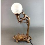 An Art Nouveau style cold cast figural table lamp, H. 47cm.