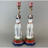 A pair of ormolu mounted porcelain dog candlesticks, H. 34cm.