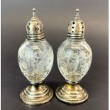 A pair of sterling silver and etched glass pepperettes, H. 9cm.