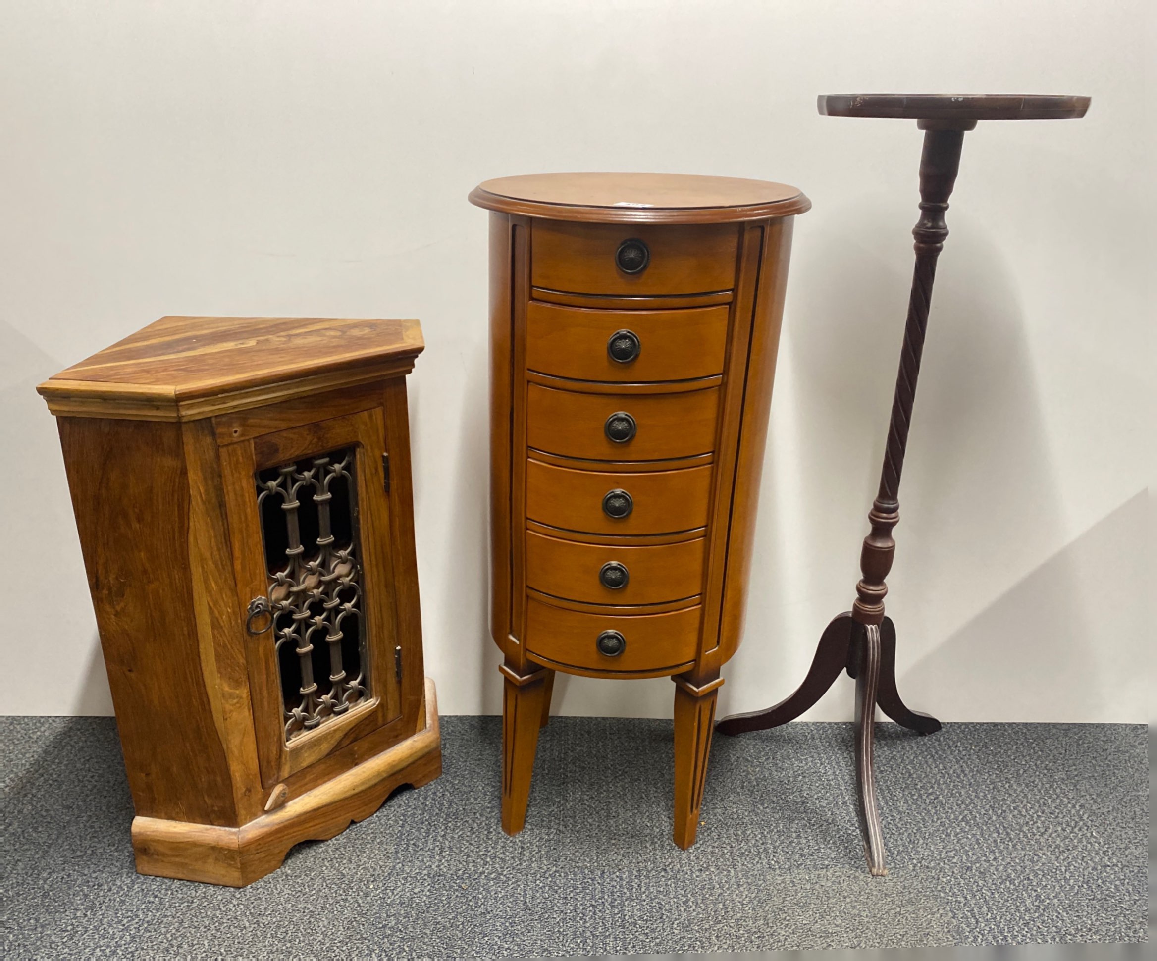 A circular six drawer chest, dia. 41cm, H. 86cm, together with a hardwood and iron corner cabinet