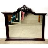 A large carved mahogany over mantle mirror, 121 x 111cm.