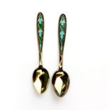 A pair of Russian Leningrad silver gilt and enamalled spoons, L. 12cm.