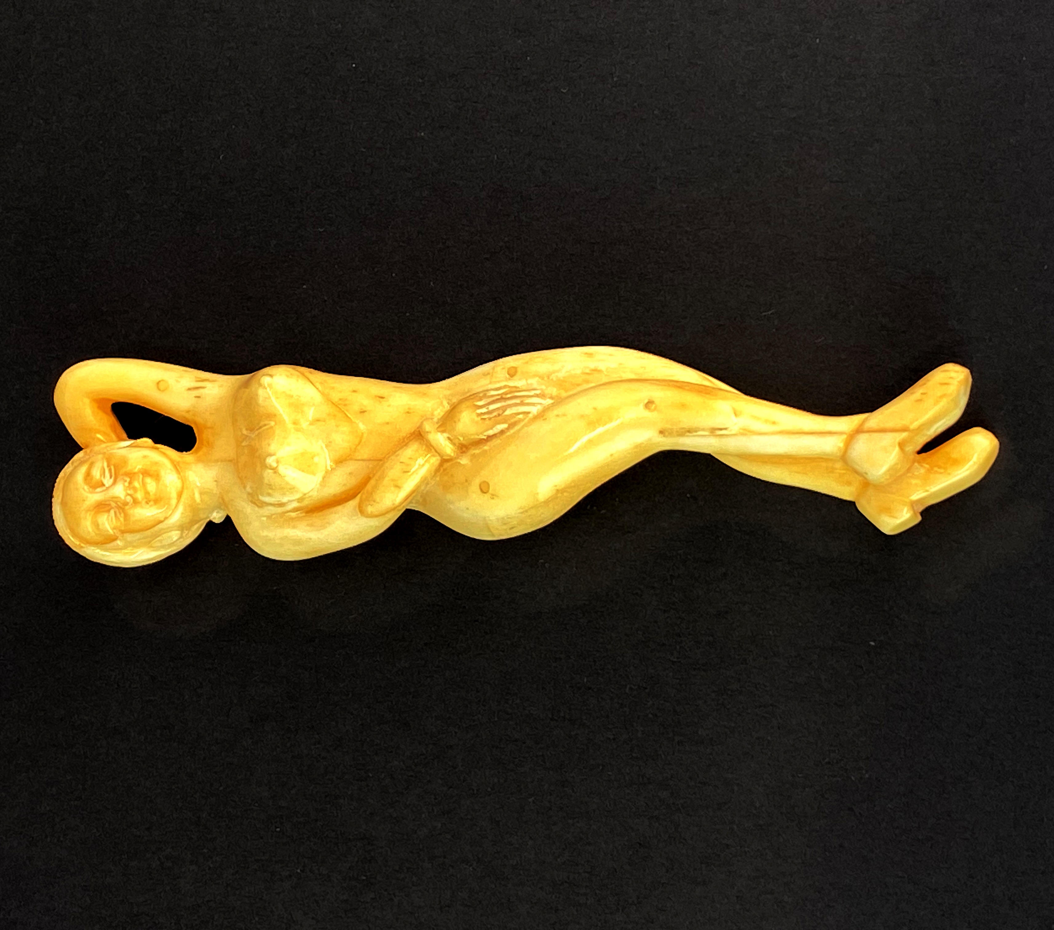 A Chinese carved bone medicine model of a young woman, L. 13cm.