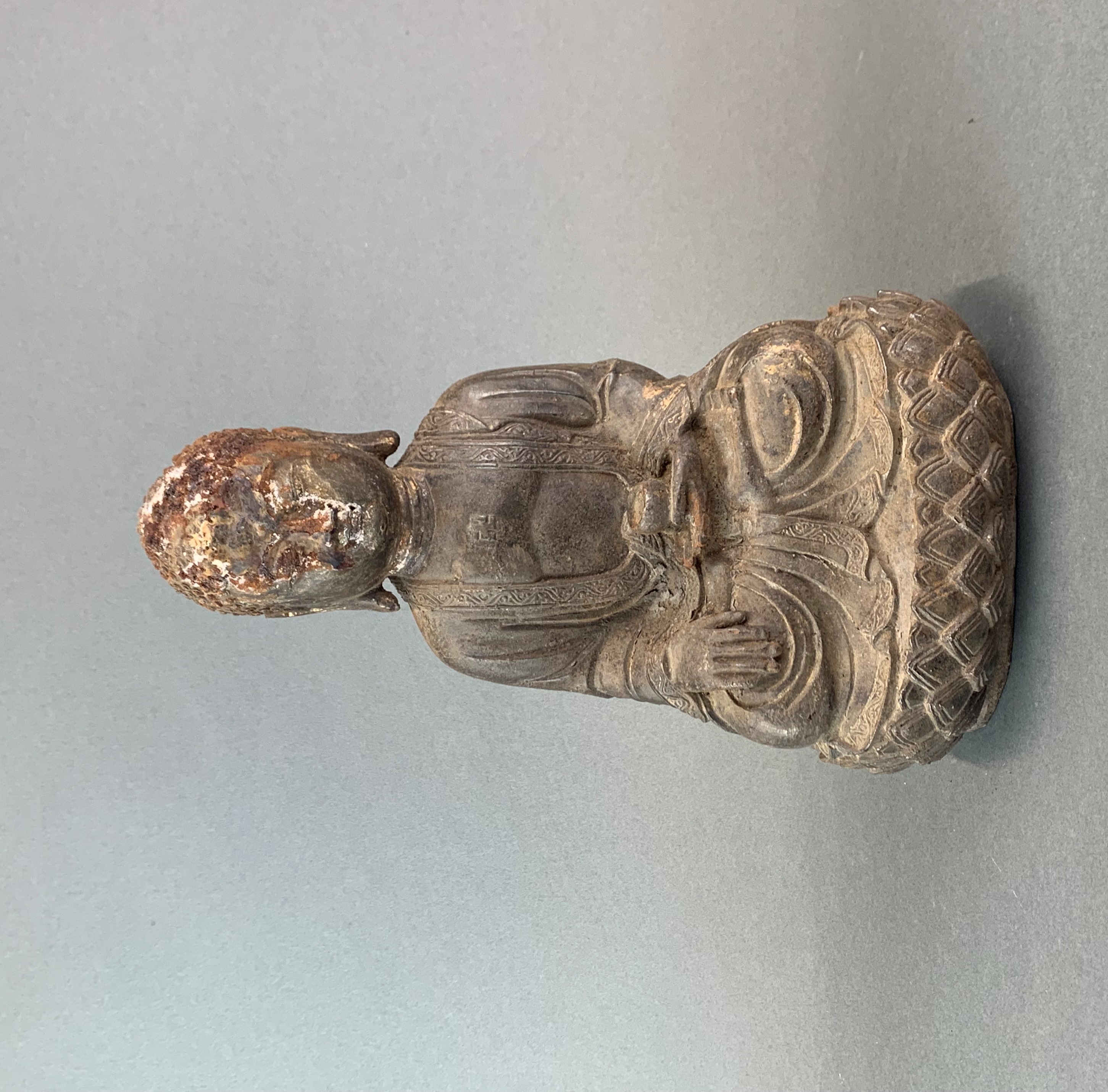 A Chinese gilt cast iron figure of a seated Buddha, H. 33cm.