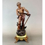 A 19th Century French spelter figure of a young farmer sharpening a scythe, H. 48cm.
