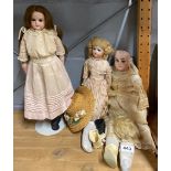Three antique porcelain head dolls, standing doll H. 45cm.