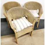 Three vintage wicker and cane armchairs.
