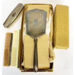 An Art Deco hallmarked silver hand mirror comb and brush with original boxes.