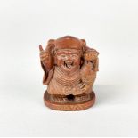A Japanese carved wooden figure of a fisherman with inset mother of pearl signature, H. 7cm.